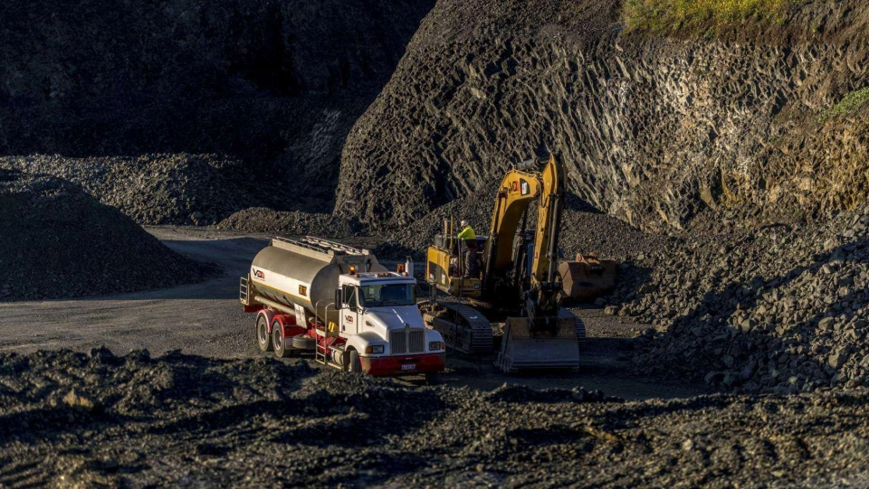 VDQ excavator and truck in quarry